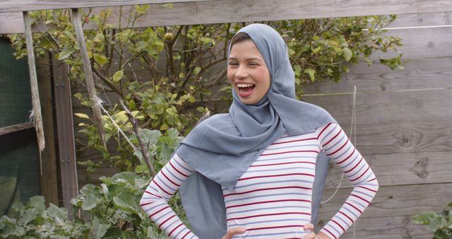 Smiling Woman in Hijab Standing in a Garden - Download Free Stock Images Pikwizard.com