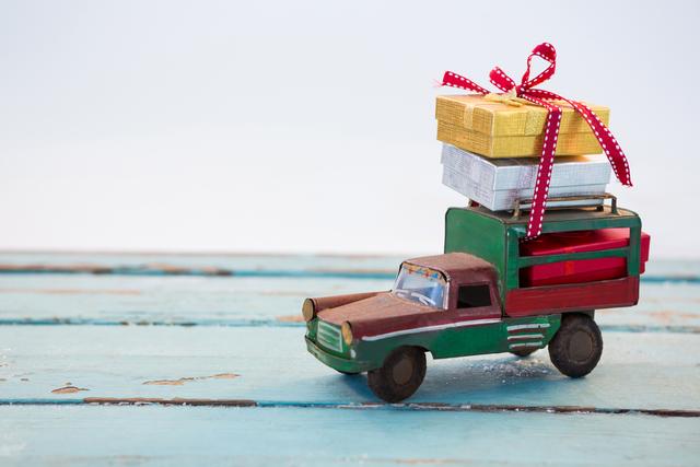 Toy Truck Carrying Christmas Presents on Wooden Plank - Download Free Stock Photos Pikwizard.com