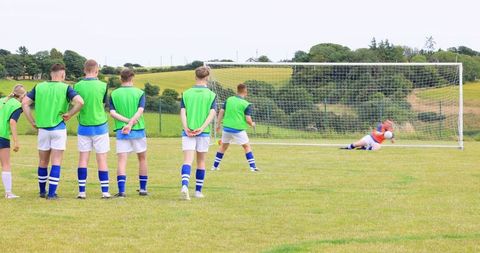 Teenagers practicing soccer trust avoidance with energetic team bonding drills