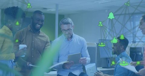 Multicultural team collaborating around tablet in open-plan office with network overlay