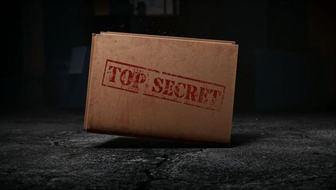 Top secret folder leaning on cracked concrete floor under dramatic spotlight