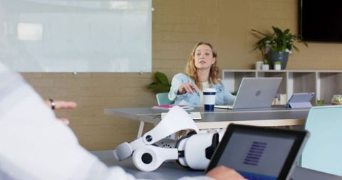 Modern Team Collaborating with Robotic Arm in Office, Woman Gesturing During Planning Meeting