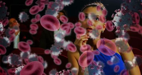 Woman in Cinema Surrounded by Virus and Blood Cells Visualization