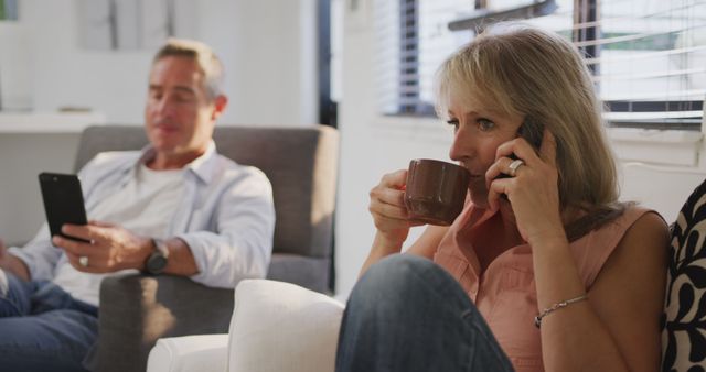 Middle-Aged Couple Relaxing at Home, Woman on Phone and Man Using Smartphone - Download Free Stock Images Pikwizard.com