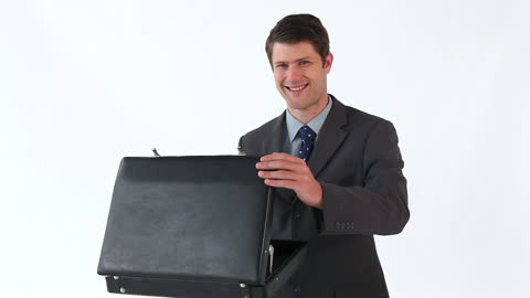 Smiling Businessman Opening Briefcase in Professional Setting