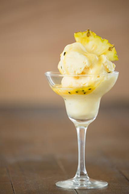 Cup of icecream decorated with a pineapple wedge - Download Free Stock Photos Pikwizard.com