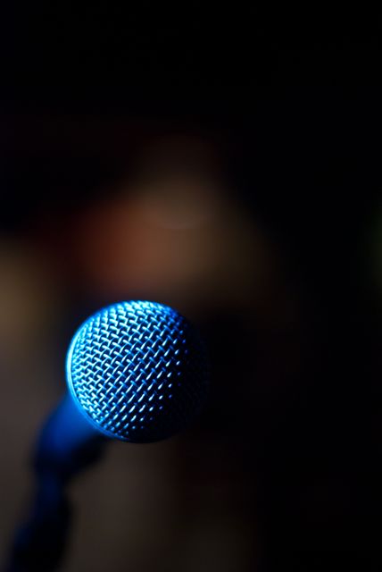 Closeup of Microphone on Stage with Blue Lighting in Background - Download Free Stock Images Pikwizard.com