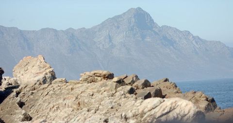Hiking on Rocky Terrain with Majestic Mountain in Background