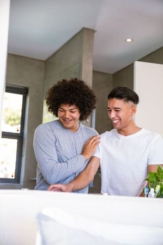 Male Friends Enjoying Relaxed Morning Routine in Modern Bathroom