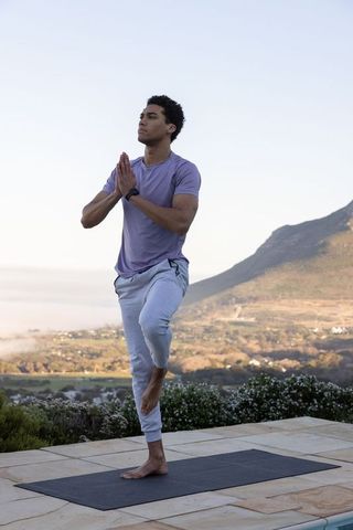 Man Practicing Yoga Outdoors on Scenic Overlook