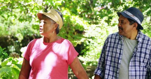 Latino Couple Strolling in Sunlit Green Park