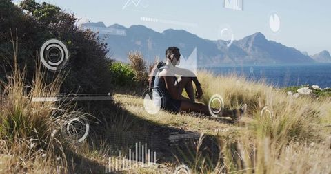 Hiker resting on coastal bluff with hud overlays, ocean vista and mountain horizon