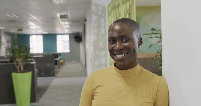 Smiling Businesswoman in Yellow Turtle Neck in Modern Office - Download Free Stock Images Pikwizard.com