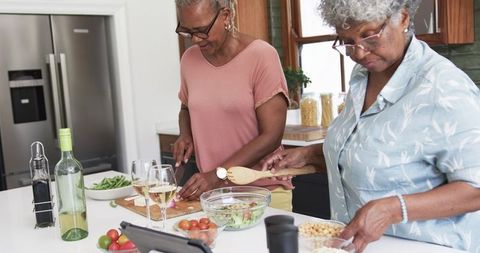 Senior African American Women Cooking and Enjoying Healthy Lifestyle