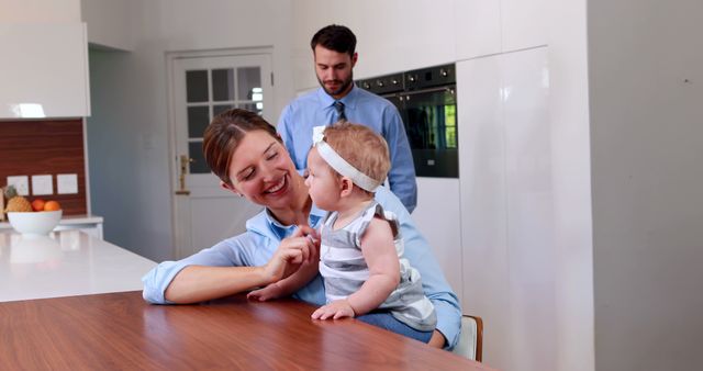 Happy family bonding with baby in modern kitchen - Download Free Stock Images Pikwizard.com