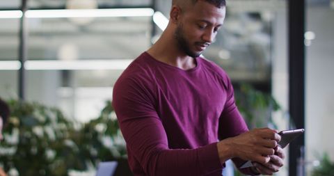 Young Professional Using Tablet in Modern Office Environment