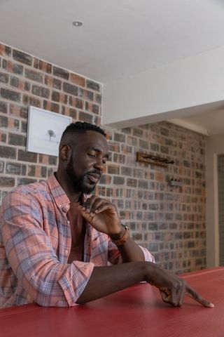 Modern Man Relaxing at Home Pointing at Intriguing Detail