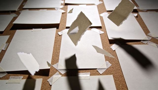 Blank Notes Lining Corkboard, Torn Paper Floating and Casting Dramatic Shadows