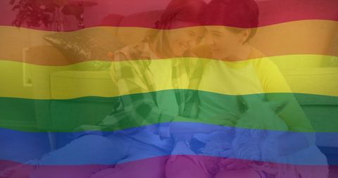 LGBTQ Pride Rainbow Flag Over Happy Lesbian Couple with Dog