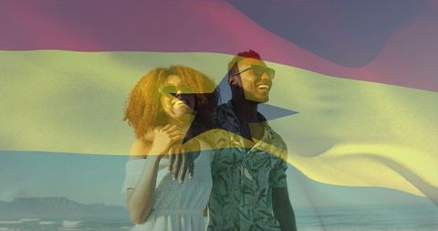 Sunlit smiling couple on beach with ghana flag overlay celebrating summer travel and romance