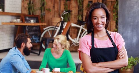 Confident Waitress Smiling in Modern Cafe Setting