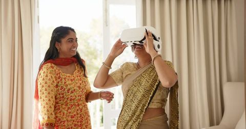 Indian mother and daughter enjoying virtual reality experience