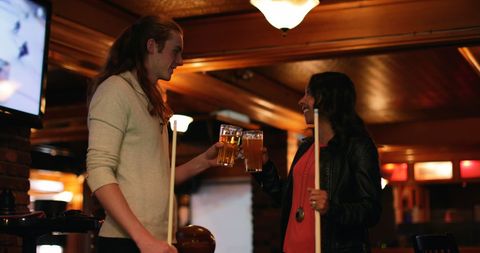 Friends Toasting Beer in Cozy Pub Ambiance