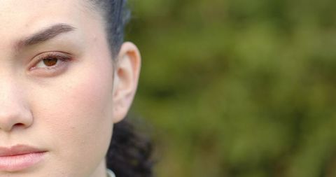 Close-up of Woman's Eye with Background Foliage