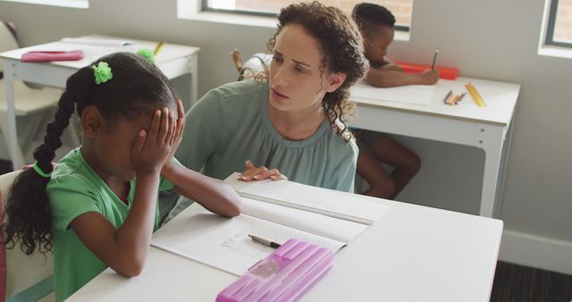 Image of caucasian female teacher supporting sad african american girl during lessons - Download Free Stock Photos Pikwizard.com