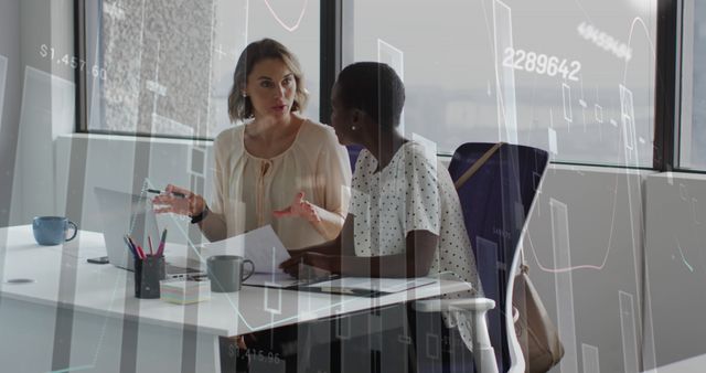 Businesswomen Discussing Data Analysis in Modern Office Environment - Download Free Stock Images Pikwizard.com