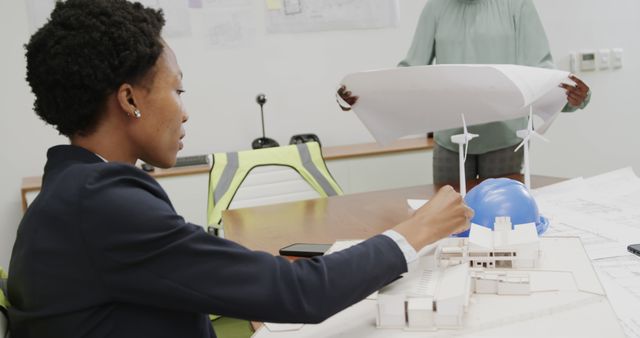 Architect Working on Sustainable Building Model at Office Desk - Download Free Stock Images Pikwizard.com