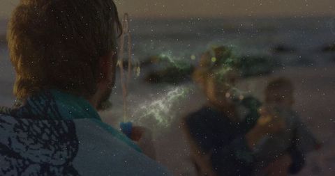 Man with Baby Enjoying Romantic Beach at Sunset