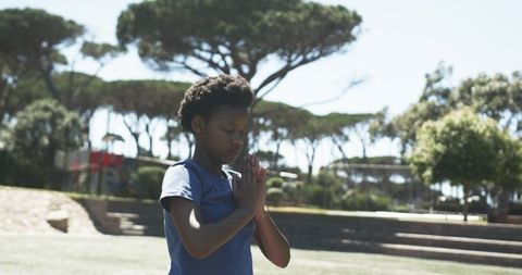 African american teen practicing meditation in sunlit park for mindful teen wellness