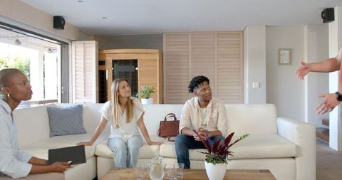 Friends Enjoying Lively Conversation in Cozy Living Room