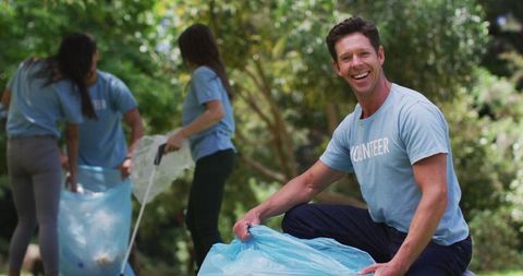 Smiling Group of Eco Volunteers in Park Clean-up Effort - Download Free Stock Images Pikwizard.com