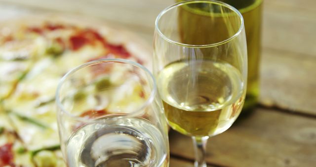 Close-up of Wine Glasses with Pizza Background - Download Free Stock Images Pikwizard.com