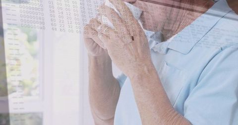Senior Caucasian Man Enjoying Coffee with Digital Data Overlay