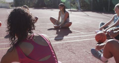 female basketball team relaxing on sunny outdoor court - Download Free Stock Images Pikwizard.com