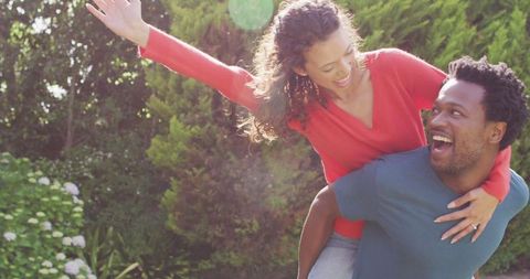 Happy couple celebrating engagement in sunny garden