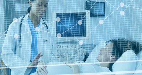 Biracial Female Doctor Assisting Pregnant Patient in High-Tech Hospital