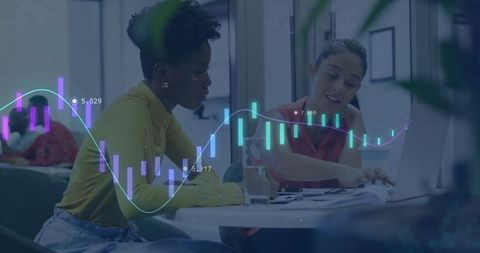 Diverse Team Analyzing Financial Data on Laptops in Contemporary Office