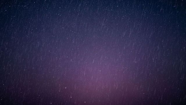 Falling rain streaks with purple gradient bokeh creating cinematic twilight mood