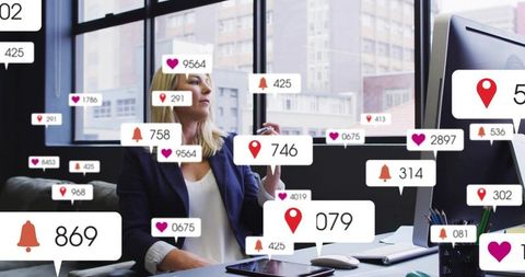 Executive woman juggling digital notifications on tablet and desktop in modern urban office