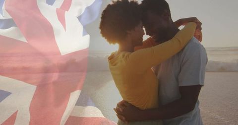 Romantic Couple Embracing on Beach with UK Flag Overlay at Sunset