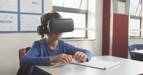 Boy Experiencing Virtual Reality Learning in Classroom