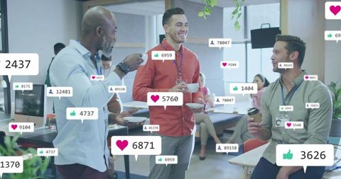 Coworkers chatting over coffee with social media engagement icons floating in modern office lounge