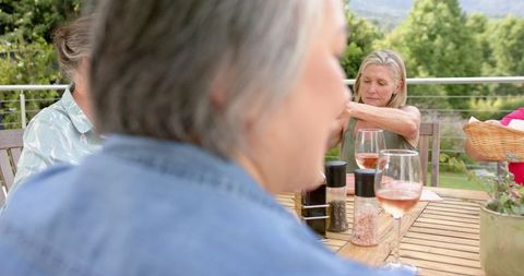 Senior Friends Socializing Outdoors Over Drinks