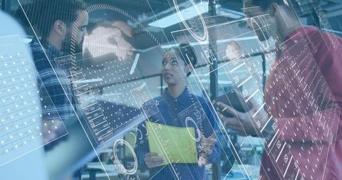 Diverse team analyzing data with futuristic technology in office