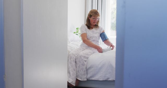 Elderly Woman Checking Blood Pressure at Home in Pajamas - Download Free Stock Images Pikwizard.com