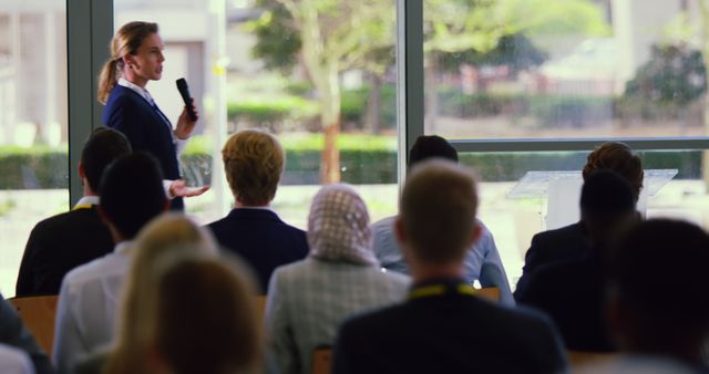 Female Business Professional Giving Presentation to Diverse Audience - Download Free Stock Images Pikwizard.com